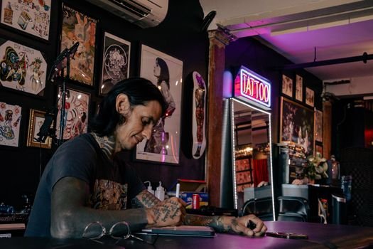 Bob Price sketching a custom tattoo design for a client